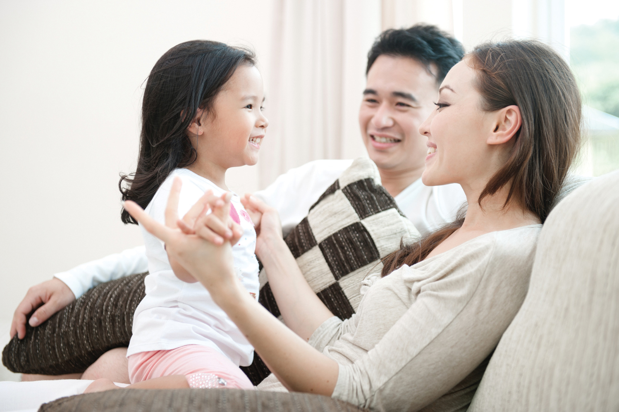 Happy Asian Family Playing with daughter in the living room